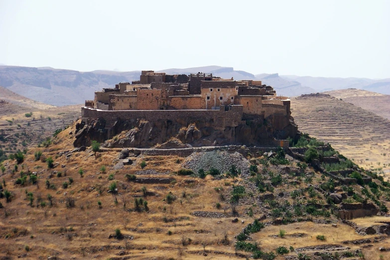 a large brown building sitting on top of a hill, a photo, flickr, les nabis, morocco, fortresses, hyperborea, photograph credit: ap