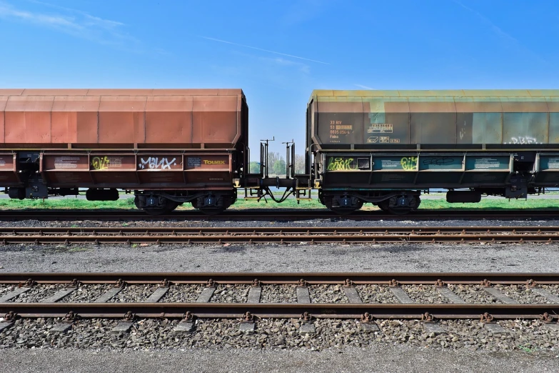 a couple of train cars sitting on top of train tracks, a portrait, by Thomas Häfner, shutterstock, in the yard, hyperdetailed!!, stock photo, trending photo