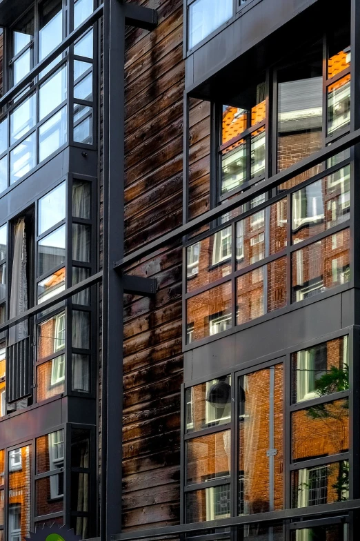 a clock that is on the side of a building, a photo, inspired by John Haberle, modernism, amsterdam, reflections specular highlights, wooden houses, shot on nikon z9