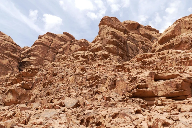 a person riding a horse through a rocky area, les nabis, wadi rum, visible from afar!!, interesting textures, usa-sep 20