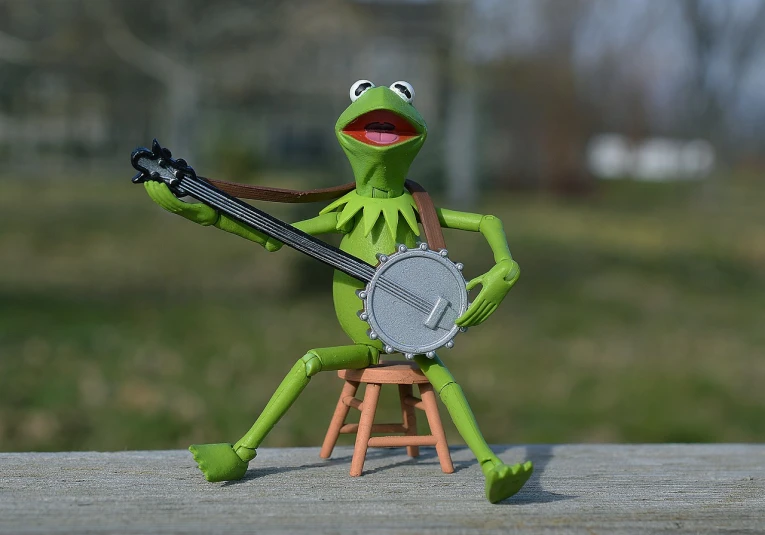 a figurine of a frog playing a banjo, a picture, by Ben Zoeller, flickr, figuration libre, kermit, afternoon hangout, 4 chan pepe, a still of a happy
