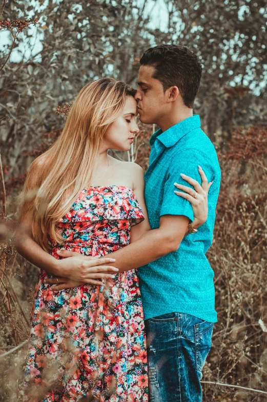 a man and woman standing next to each other in a field, a colorized photo, by david rubín, pexels, romanticism, attractive girl, kiss, avatar image, floral clothes