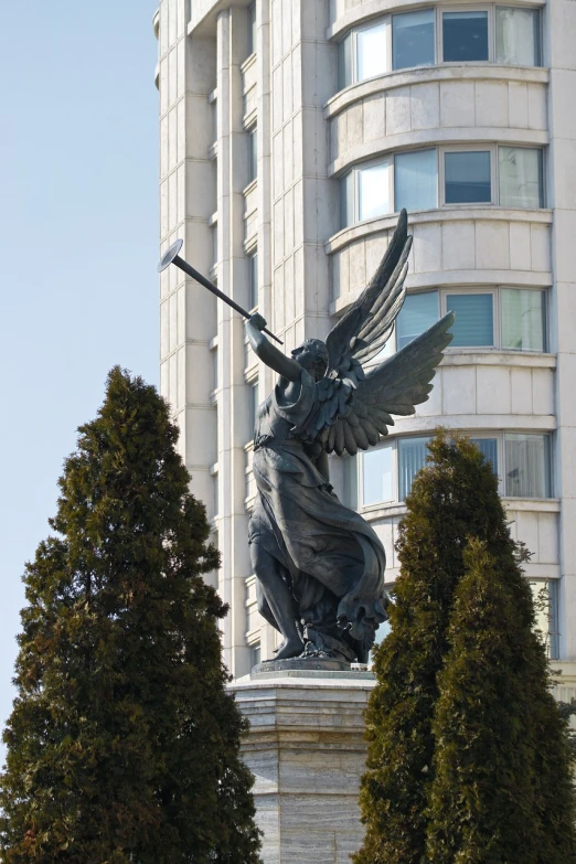 a statue of an angel holding a spear in front of a building, by Vladimir Borovikovsky, seoul, large wings, victory, 2 0 1 0 photo