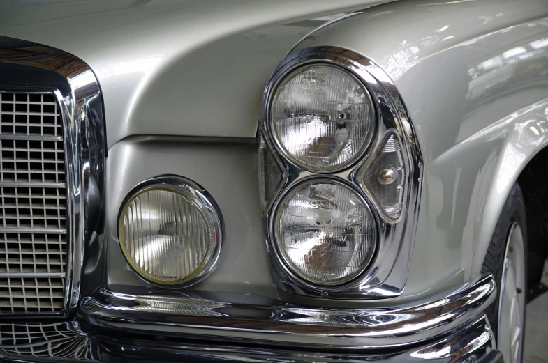 a close up of the headlights of a car, by Jürg Kreienbühl, flickr, photorealism, restored, mercedes, symmetrical rim light, interior light