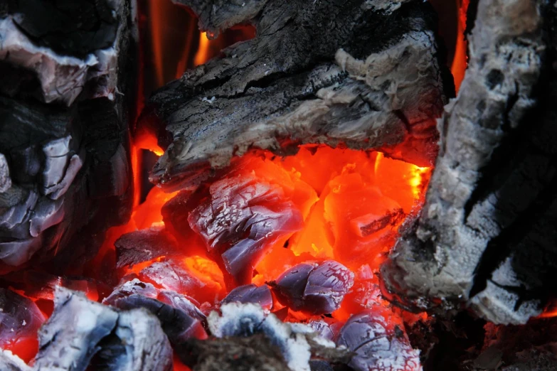 a close up of a fire with coal in it, a picture, by Alexander Scott, hurufiyya, cozy environment, qiangshu, coloured, wallpaper - 1 0 2 4
