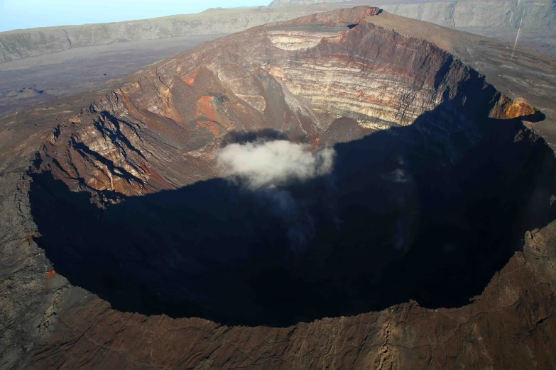 a large crater in the middle of a mountain, a picture, by Yasushi Sugiyama, flickr, the great door of hell, black volcano afar, wikimedia commons, maui