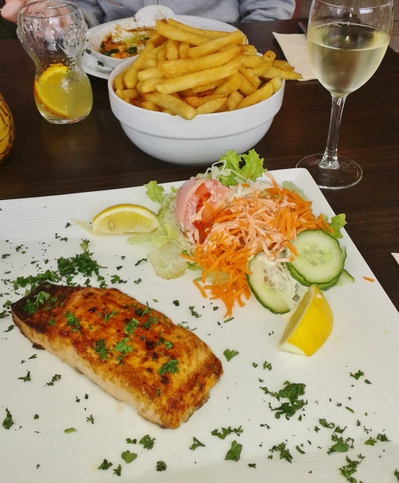 a close up of a plate of food on a table, les nabis, salmon, french fries, meni chatzipanagiotou, very detailed picture