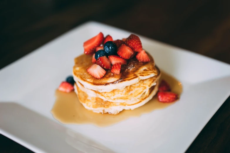 a stack of pancakes topped with strawberries and syrup, a portrait, by Niko Henrichon, pexels, offering a plate of food, daily specials, ivy's, 1811