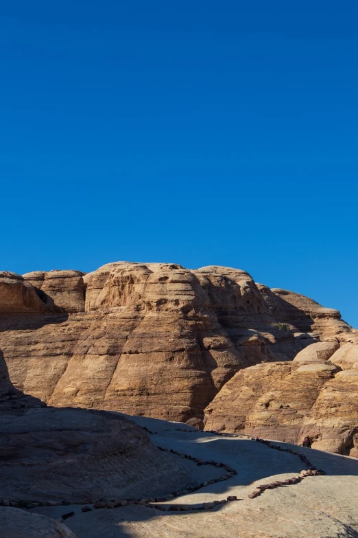 a man riding a snowboard down a snow covered slope, a detailed matte painting, shutterstock, minimalism, wadi rum, tourist photo, rock roof, wide shot photo