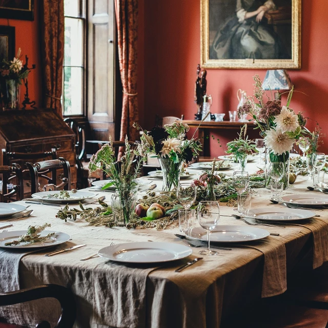 a table that has a bunch of plates on it, a still life, by Elsa Bleda, pexels, arts and crafts movement, richly decorated victorian house, long table, linen, busy room