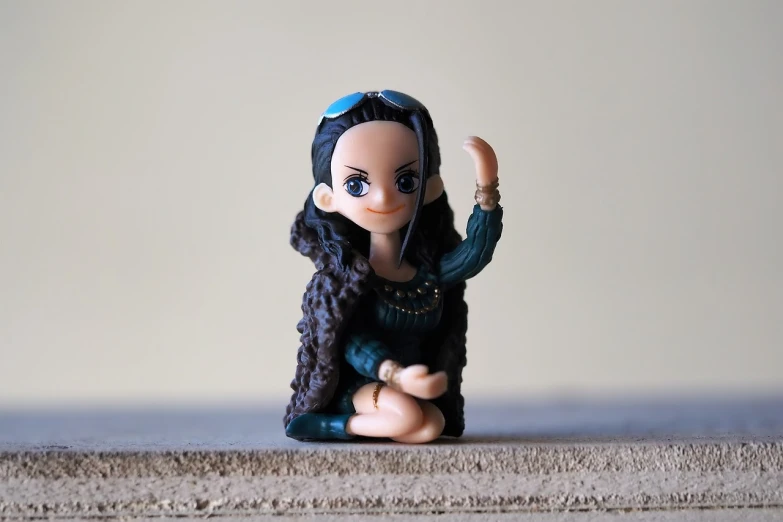 a close up of a figurine of a woman, a picture, figuration libre, chibi style, young beautiful hippie girl, serpentine pose gesture, sitting down casually
