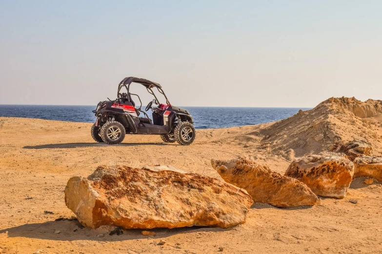 a buggy sitting on top of a sandy beach, a portrait, shutterstock, from egypt, high quality photos, cliffjumper, set photo