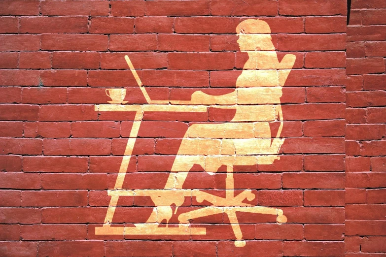 a woman sitting at a desk in front of a laptop computer, by Douglas Shuler, pixabay, computer art, painted on a brick wall, stylized silhouette, sitting on designer chair, stock photo