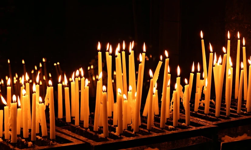 a bunch of candles are lit in a dark room, a picture, shutterstock, baroque, ossuary, hedi slimane, lots of sunlight, greek