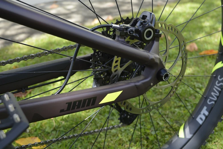 a close up of the front wheel of a bicycle, fuji choco, whip, immense details, close-up shot from behind