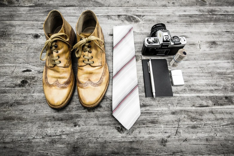 a pair of shoes, a tie, and a camera on a wooden floor, a photo, cinematic outfit photo, wet plate photo, selfie photo, working hard