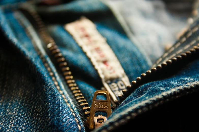 a close up of a zipper on a pair of jeans, by Daniel Ljunggren, happening, flickr explore 5 0 mm, gold details, open, vintage clothing