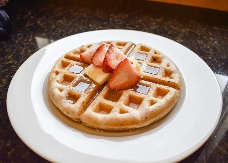 a waffle sitting on top of a white plate, by Jason Felix, description, fluffy, next to sliced strawberries, grain”