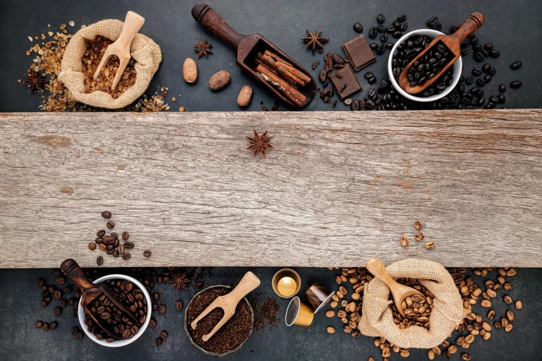 a table topped with coffee beans and spices, by Andries Stock, trending on pexels, visual art, on an empty stage from above, star, banner, rustic