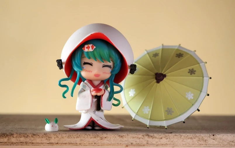 a close up of a doll with an umbrella, a picture, inspired by Hishikawa Moronobu, pixiv, mingei, a happy meal toy of hatsune miku, 9 0 mm studio photograph tiny, japanesse farmer, it's wearing a cute little hat