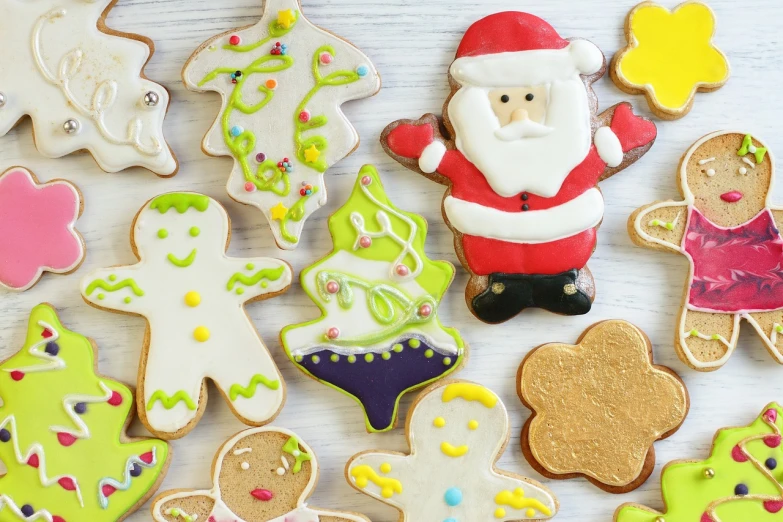 a number of decorated cookies on a table, a picture, pexels, istockphoto, santa, tony roberts, performance