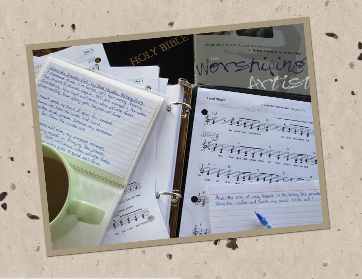 a notepad sitting on top of a binder next to a cup of coffee, an album cover, inspired by John Platt, worship, with some hand written letters, sheet music, full subject shown in photo