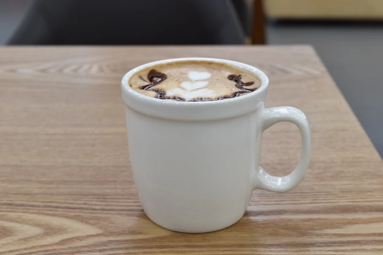 a close up of a cup of coffee on a table, shutterstock, photorealism, benjamin vnuk, milk and mocha style, intricately designed, white mug