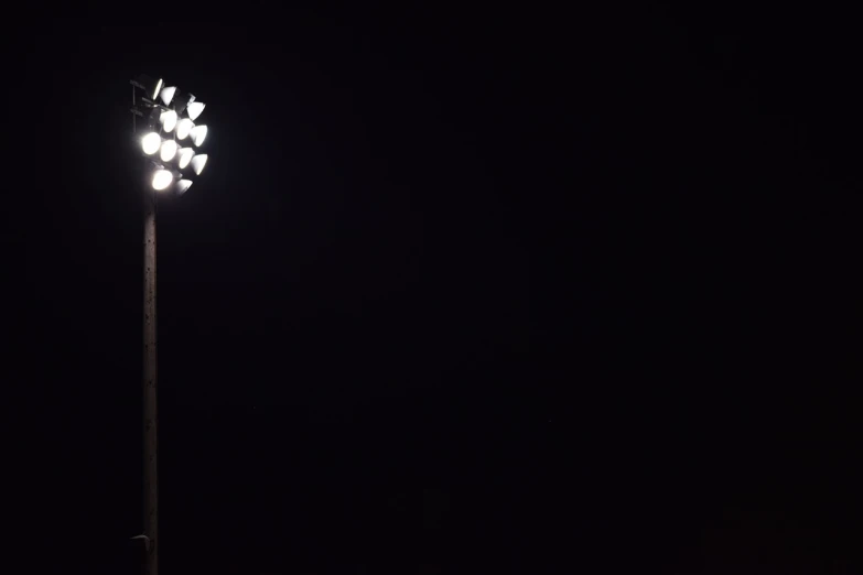 a light that is on a pole in the dark, shutterstock, minimalism, dramatic stadium lighting, 4 0 0 mm f 1. 2, telephoto, 2 0 0 mm telephoto