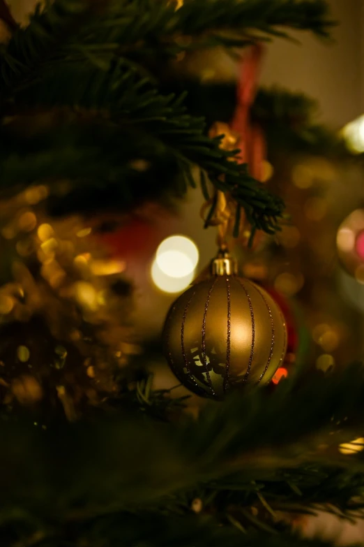 a close up of a christmas ornament on a tree, by Maksimilijan Vanka, pexels, gold dappled lighting, avatar image, decoration around the room, andrzej marszalek