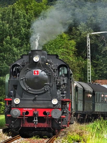 a train traveling down train tracks next to a forest, a portrait, by Jörg Immendorff, pixabay, brass and steam technology, summer day, festivals, leaving for battle