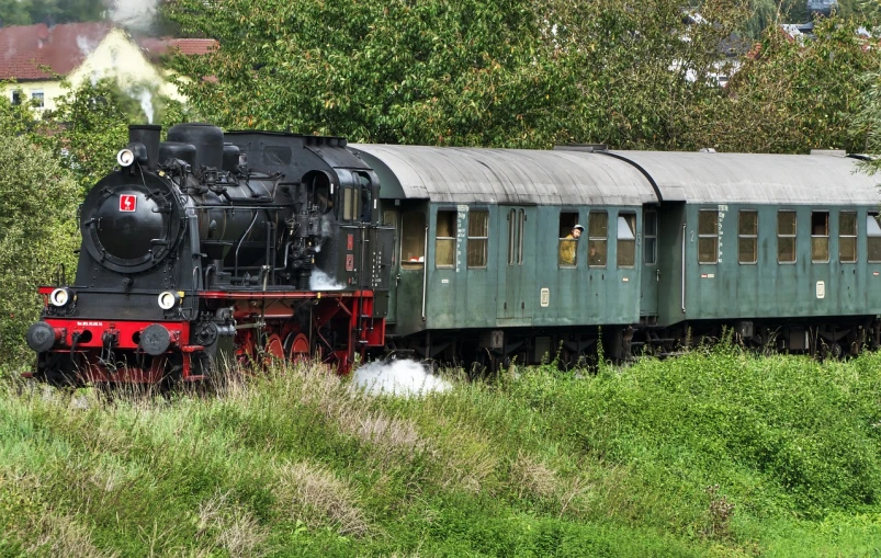 a train traveling through a lush green countryside, by Werner Gutzeit, pixabay, art nouveau, set in ww2 germany, big engine, vintage - w 1 0 2 4, panorama shot