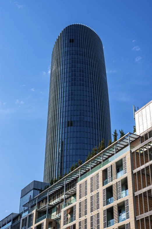 a tall building sitting in the middle of a city, a picture, by Michalis Oikonomou, shutterstock, in barcelona, capital plaza, close up shot from the side, high quality photos