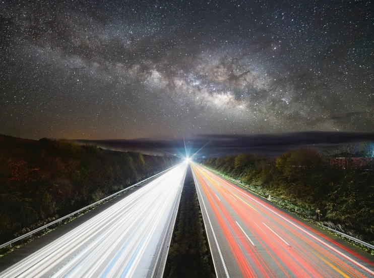 a long exposure photograph of a highway at night, by Thomas Häfner, shutterstock, light and space, milky way galaxy, with spaceships in the sky, top down photo, car photography