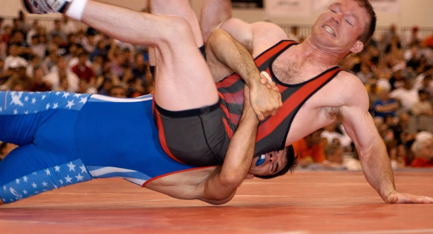 a man wrestling another man in a wrestling match, a photo, leotard, wikimedia commons, closeup - view, john kricfalusi