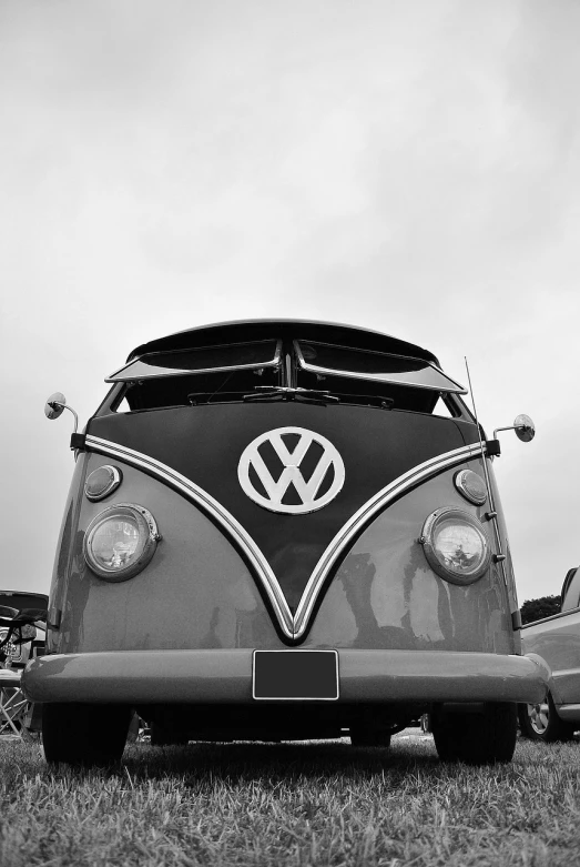 a black and white photo of a vw bus, a black and white photo, v - fin, perfect shading, cars, nose