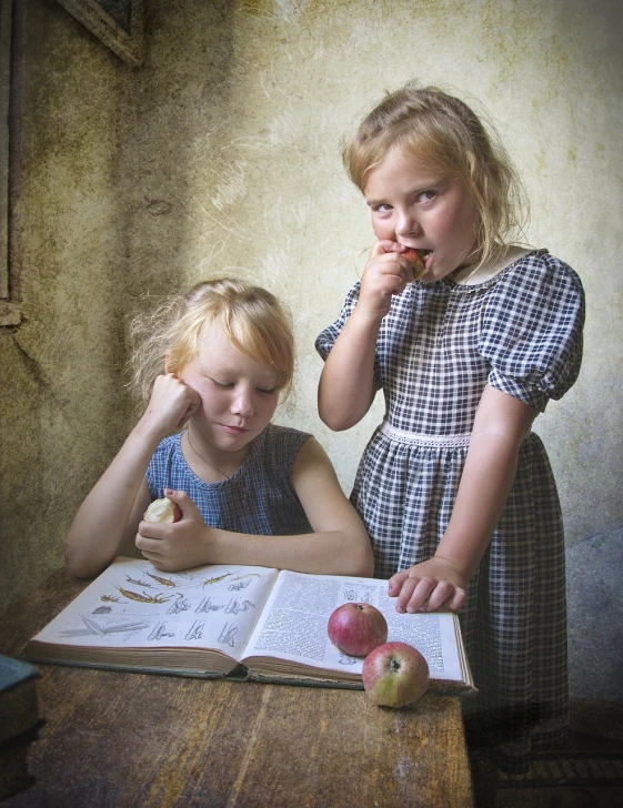two little girls sitting at a table with an open book, a still life, inspired by Albert Anker, flickr contest winner, art photography, apples, by rainer hosch, artistic!!! composition, licking