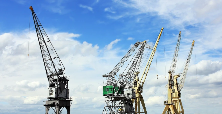 a group of cranes sitting on top of a body of water, shutterstock, figuration libre, executive industry banner, hull, platforms, watch photo