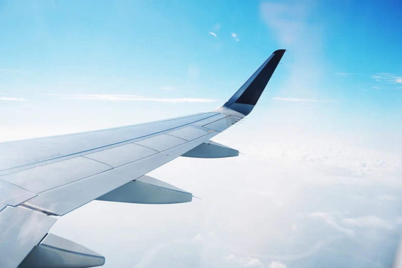 the wing of an airplane flying in the sky, a picture, shutterstock, minimalism, a wide full shot, comfortable, flat, usa-sep 20