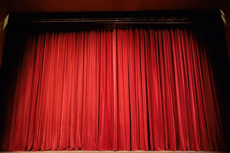 a close up of a red curtain on a stage, a picture, by Eva Gonzalès, pexels, stock photo, ground-level view, college, facing to audience