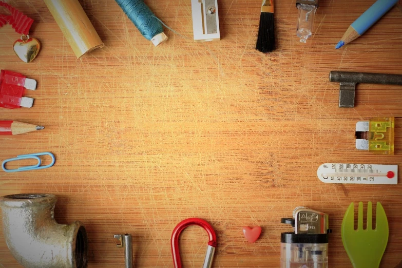 a wooden table topped with lots of different tools, a portrait, pexels, scratched photo, mobile wallpaper, knickknacks, enhanced photo