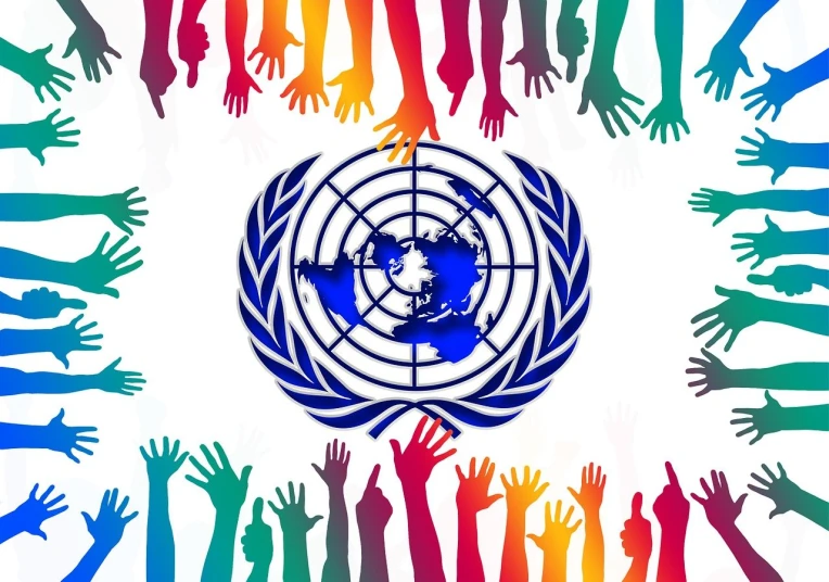 a group of multicolored hands surrounding a globe, a stock photo, unilalianism, united nations, unco corporate banner, official fan art, closeup of arms