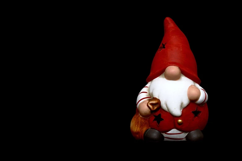 a close up of a figurine of a gnome, a photo, minimalism, wide screenshot, heavy vignette!, christmas, chiaoscuro