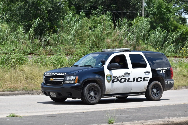 a police car is parked on the side of the road, a photo, by Linda Sutton, pixabay, photorealism, tx, photo taken in 2018, gary houston, stock photo