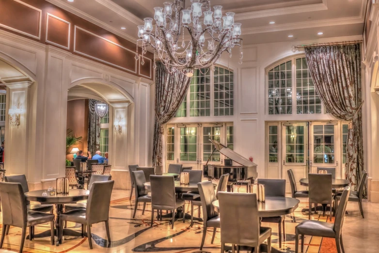 a dining room filled with lots of tables and chairs, a portrait, by Robbie Trevino, cg society contest winner, ballroom background, tonemapped, grand piano, resort