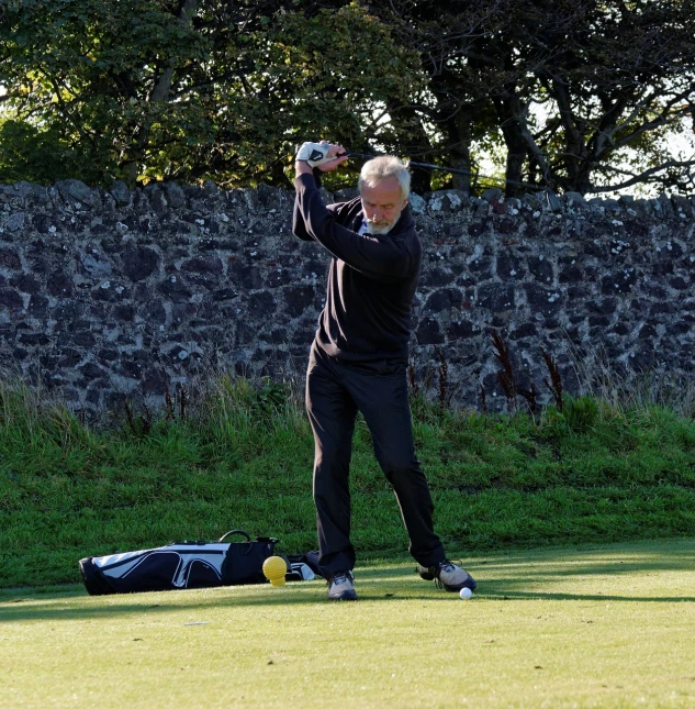 a man standing on top of a lush green field, a photo, by Alison Watt, flickr, happening, mid action swing, iain mccaig, off - putting, patrick nagle!!!