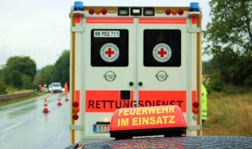 an ambulance is parked on the side of the road, a picture, by Caroline Mytinger, symbol for the word ersatz, high casualties, backpfeifengesicht, hazmat