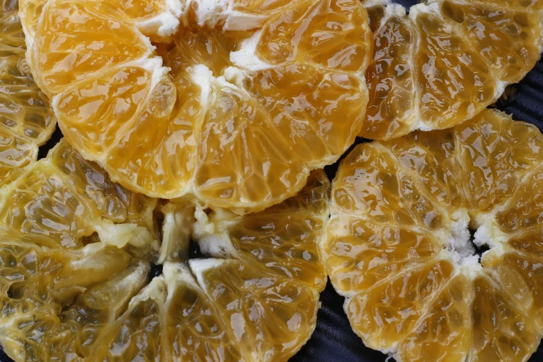 a close up of a bunch of orange slices, by Dietmar Damerau, process art, tremella fuciformis, highly detailed photo, glazed, taiwan