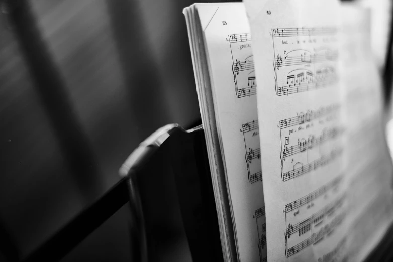 a sheet of music sitting on top of a piano, a picture, by Matthias Weischer, pexels, happening, b & w detailed sharp photo, open book page, closeup photograph, cello