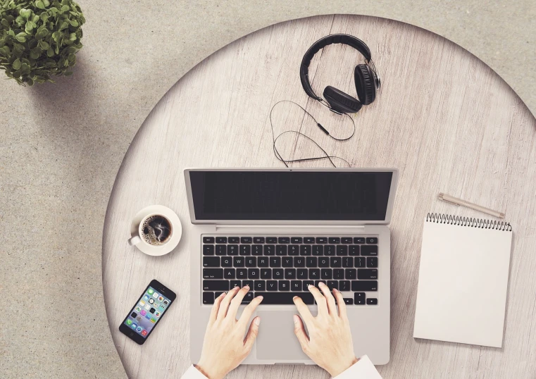 a person sitting at a table with a laptop and headphones, a computer rendering, by Kurt Roesch, pexels, flatlay, elegant intricate, round format, istockphoto