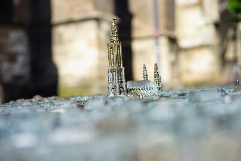 a close up of a model of a building, a tilt shift photo, modernism, trident metal crown, cathedral background, miniature product photo